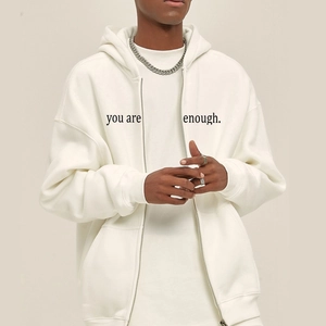 Oversized white zip-up hoodie with 'you are enough' print and drop shoulder design