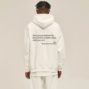 Detail view of the quote print on back of a cream oversized drawstring hoodie