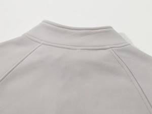 Close-up of light gray ribbed knit polo sweatshirt showing stand-up collar and stitching