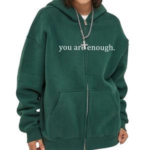 Deep green oversized zip-up hoodie featuring a smooth metal zipper and kangaroo pocket