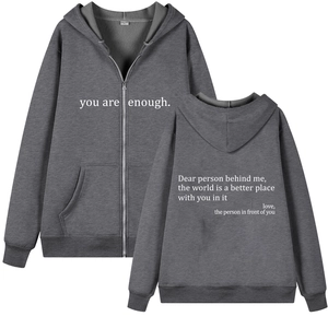 Detail view of the deep gray zip-up hoodie featuring white slogan print and size L label