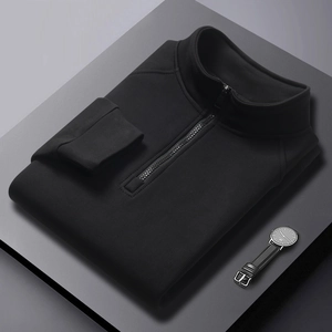 Detailed macro view of black quarter-zip sweatshirt with fine ribbed texture on gray stand