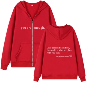 Front and back view of red oversized zip-up hoodie featuring you are enough text print