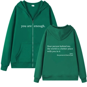 Detail view of green zip-up hoodie featuring you are enough print and fleece texture