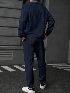 Detail of navy blue men sport set with herringbone knit texture and athletic fit pants