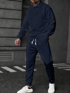 Detail view of navy blue long sleeve polo set with premium herringbone knit texture