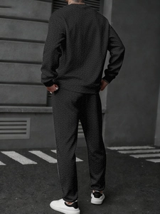 Detail view of the deep grey herringbone texture on men's long sleeve polo tracksuit