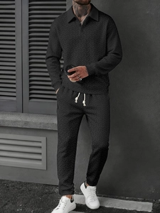 Detail of black knit polo tracksuit with wheat grain texture and white drawstrings