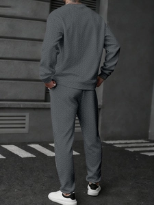 Detailed back view of men's grey tracksuit featuring a unique chevron knit texture