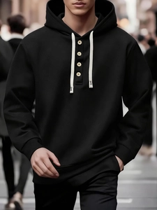 Close-up of black men's hoodie showing henley neck with buttons and white drawstrings