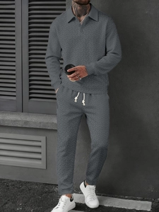 Detail of grey men's polo set showing wheat texture knit and contrast drawstring