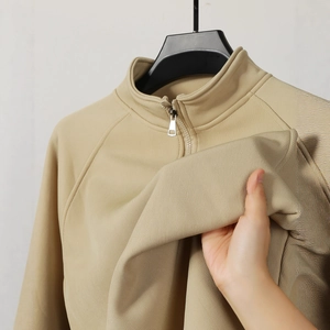 Men's khaki half-zip polo sweatshirt with premium ribbed texture and raglan sleeves
