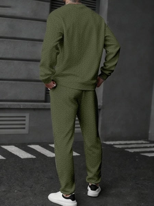 Rear view of olive green tracksuit set with unique wheat pattern texture on street