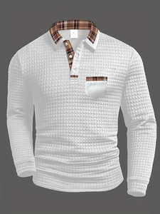 Detail of waffle knit fabric and classic brown plaid trim on white polo shirt pocket