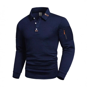Close-up of waffle texture fabric and sleeve pocket with orange zipper on blue polo shirt