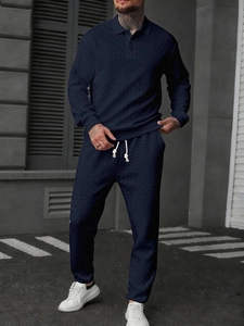 Detail of navy blue men's polo set featuring high-density herringbone knit texture fabric
