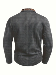 Close-up of men's dark grey waffle knit polo showing brown plaid lining inside the collar