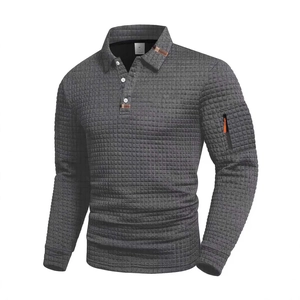 Detail of waffle textured long sleeve polo shirt with zipper pocket and plaid collar