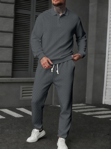 Detailed texture of dark grey men's long sleeve polo and drawstring pants set