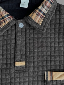Detail of waffle texture fabric and plaid patchwork collar on men's polo shirt