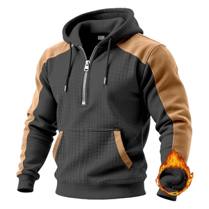 Detail of men's quilted hoodie showing color block design and fleece thermal lining