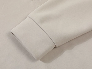 Detailed close-up of ribbed cuffs and high-quality knitted fabric on men hoodie