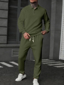 Detail of olive green men's long sleeve polo shirt and matching pants with texture