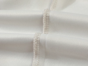 Close-up of white ribbed knit fabric texture and high-quality stitching on hoodie