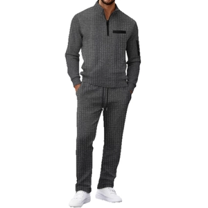 Men's grey tracksuit featuring textured checkerboard fabric with half-zip polo collar