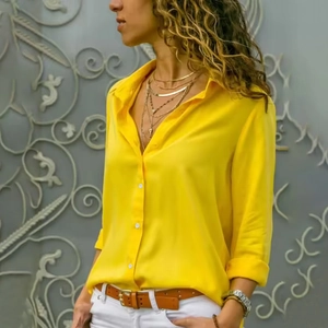 Fashionable bright yellow long-sleeve women shirt with white buttons and turn-down collar