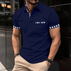 Close-up of navy polo shirt with gingham check patterns on the collar and pocket trim