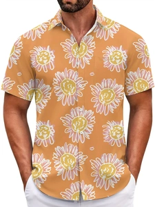 Detail of vibrant orange Hawaiian shirt featuring white and pink sunflower prints