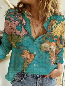 Detailed close-up of a blue long sleeve shirt featuring a vintage world map print pattern