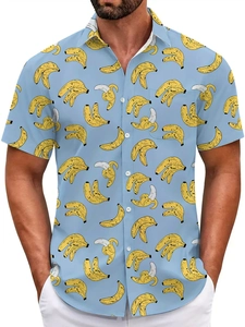 Close-up of tropical yellow banana print on a light blue short sleeve summer beach shirt