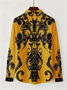 Detail of yellow satin shirt featuring black Baroque scroll patterns and sleeve texture