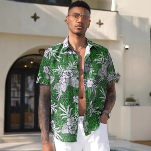 Detail of green Hawaiian shirt with white floral prints and modern lapel collar