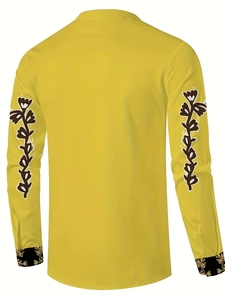 Detail view of mustard yellow shirt back showing floral sleeve prints and ethnic cuffs