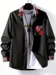 Detail of black shirt collar and pocket with red plaid patchwork and button features