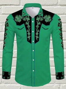 Detail of green and black western shirt featuring floral embroidery on the shoulders and cuffs