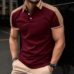 Detail of burgundy polo shirt with khaki patchwork and white buttons on men's top