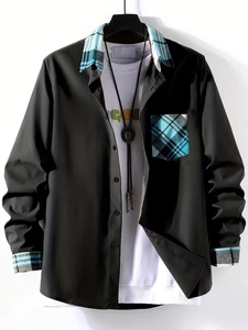 Detail view of black men's shirt with blue plaid patchwork on collar, pocket and sleeve cuffs