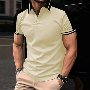 Detail of color-block polo shirt featuring beige body and black sleeves with striped cuffs