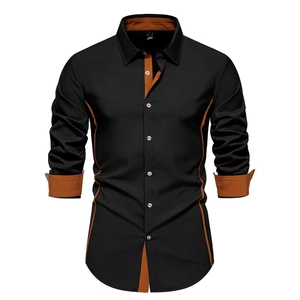 Detail of slim fit black shirt with contrast orange lining on collar and cuffs