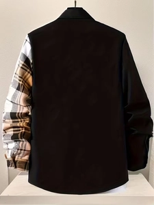 Detail of men's long sleeve shirt featuring asymmetric black fabric and plaid sleeve