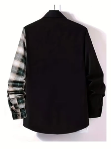 Detail of men's black shirt featuring green and white plaid patchwork on the long sleeve