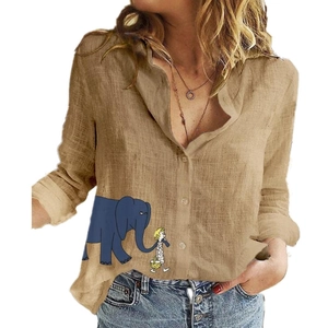 Detail of khaki linen shirt featuring cartoon elephant and girl illustration print