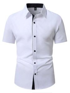 Detail of white short sleeve shirt showing black contrast collar and button placket texture