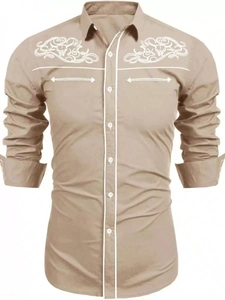Detail of western shirt featuring white floral embroidery and contrast piping on the shoulders