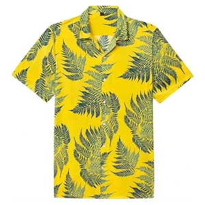 Close-up of bright yellow men's beach shirt with detailed green fern leaf prints