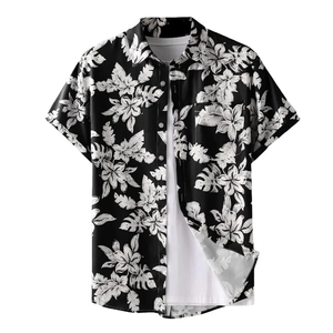 Close-up of black and white tropical palm leaf print on a men's short sleeve shirt
